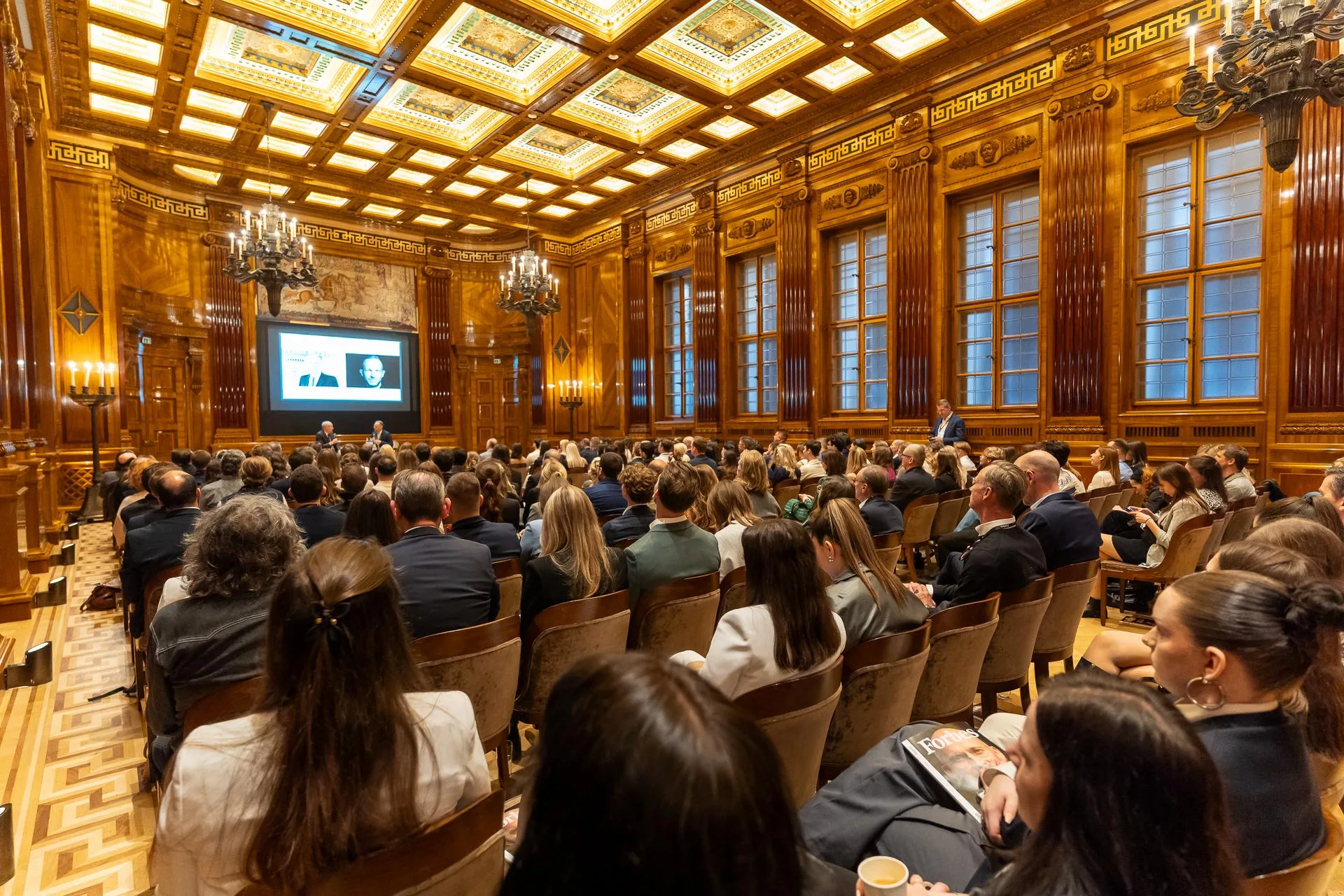 Executive management training session in a wood-panelled hall